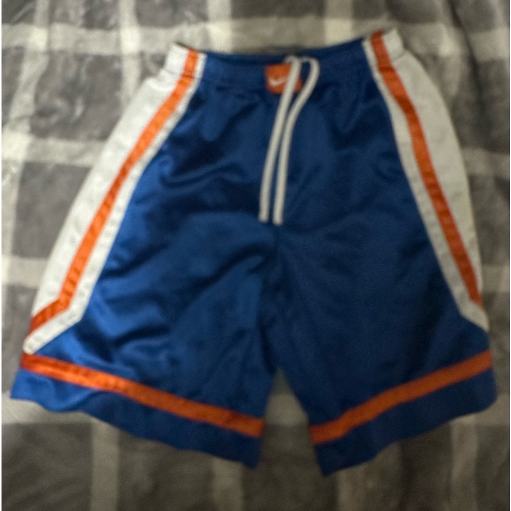Blue, orange, and white Nike basketball shorts